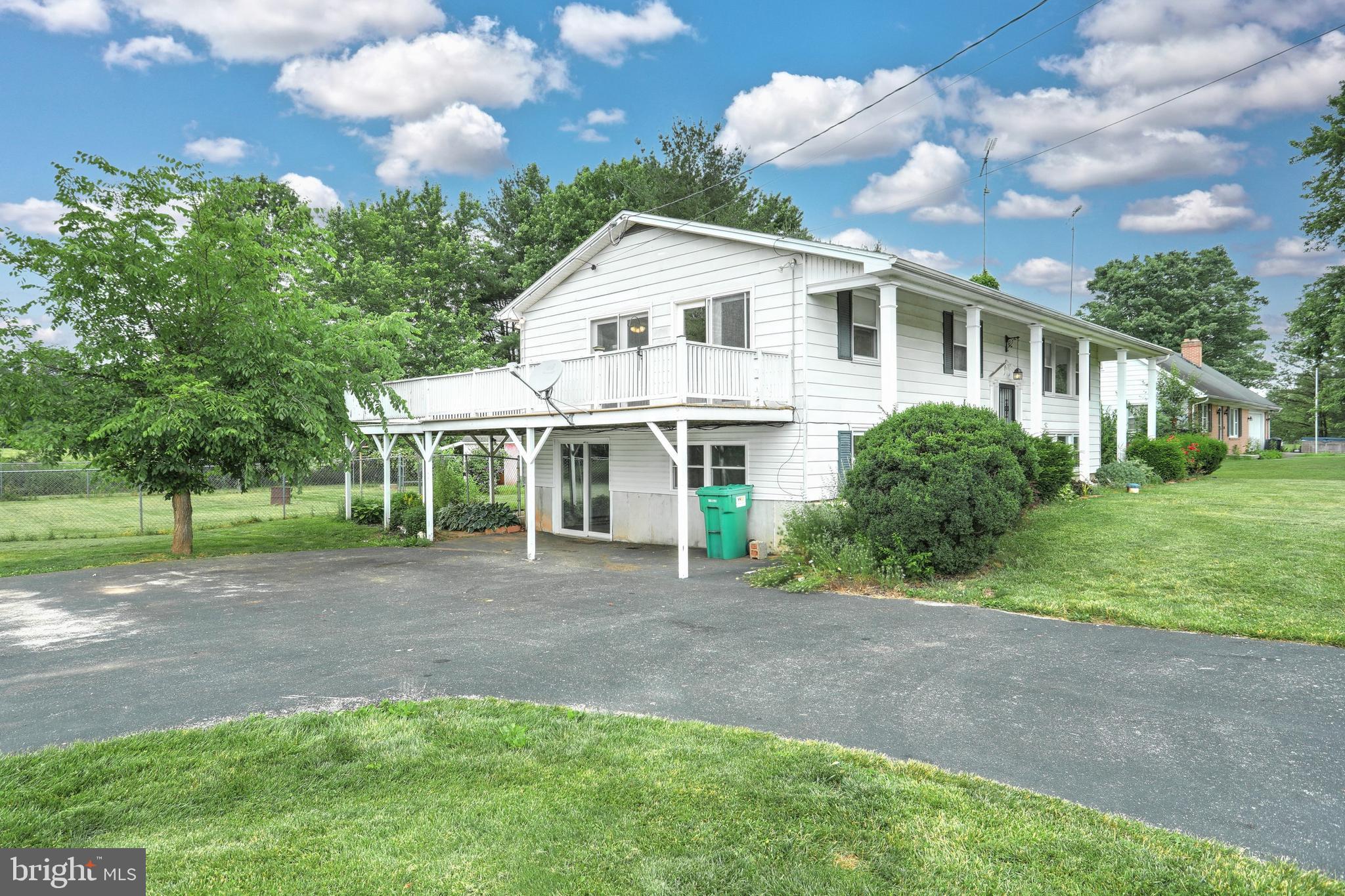 147 Mud College Road Littlestown, PA 17340 - Photo 2 of 43 a view of a white house next to a yard with big trees
