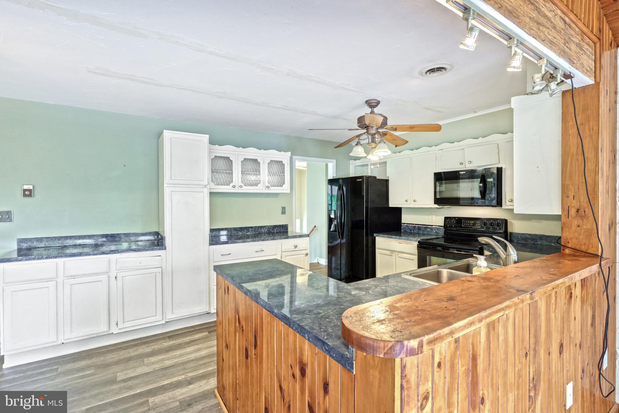 147 Mud College Road Littlestown, PA 17340 - Photo 11 of 43 a kitchen with granite countertop a sink stove and cabinets