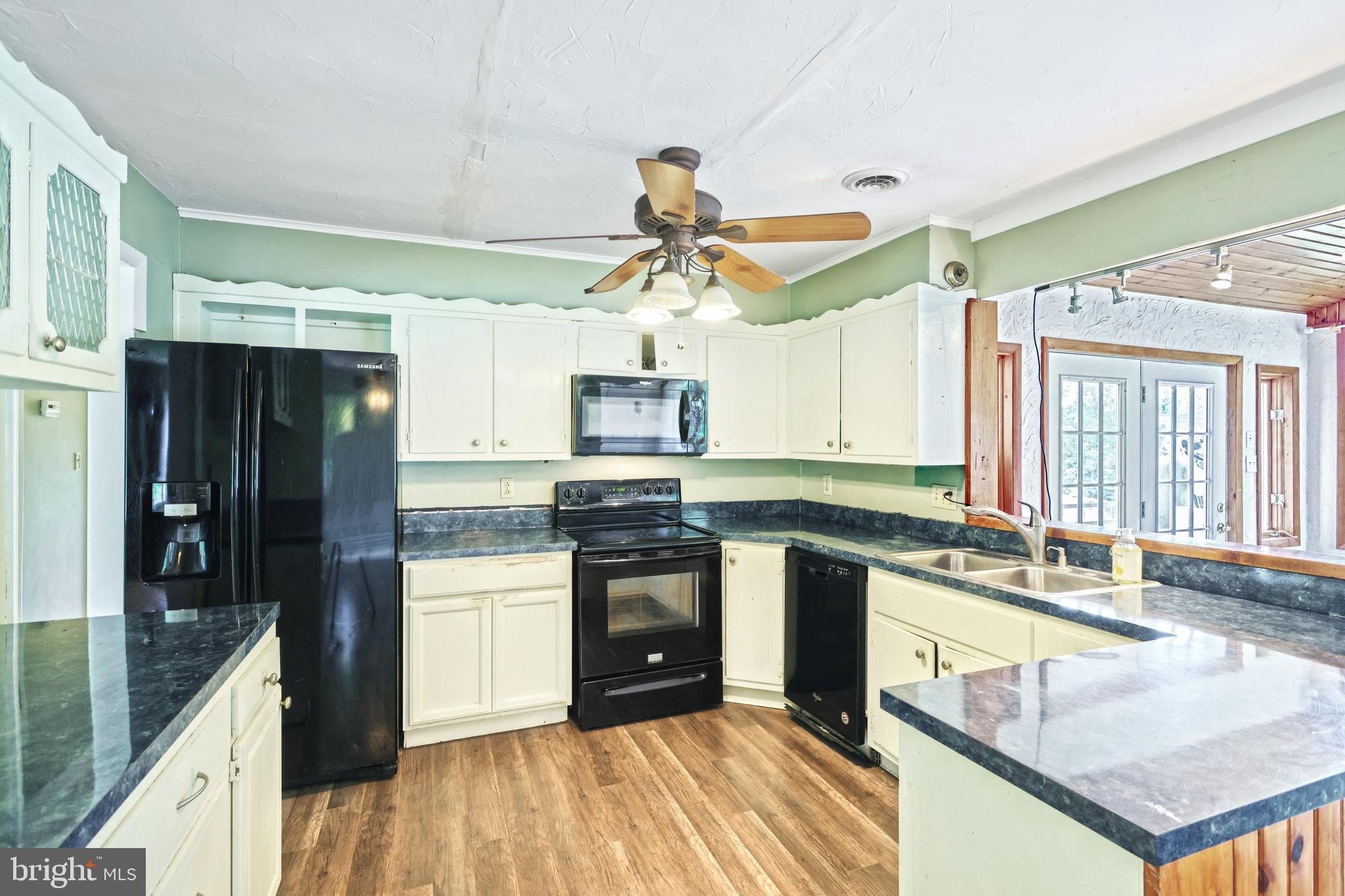 147 Mud College Road Littlestown, PA 17340 - Photo 12 of 43 a kitchen with stainless steel appliances granite countertop a sink a stove and a refrigerator