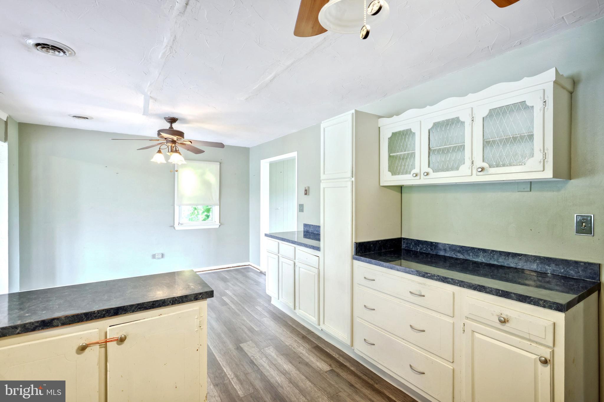 147 Mud College Road Littlestown, PA 17340 - Photo 15 of 43 a kitchen with granite countertop white cabinets and window