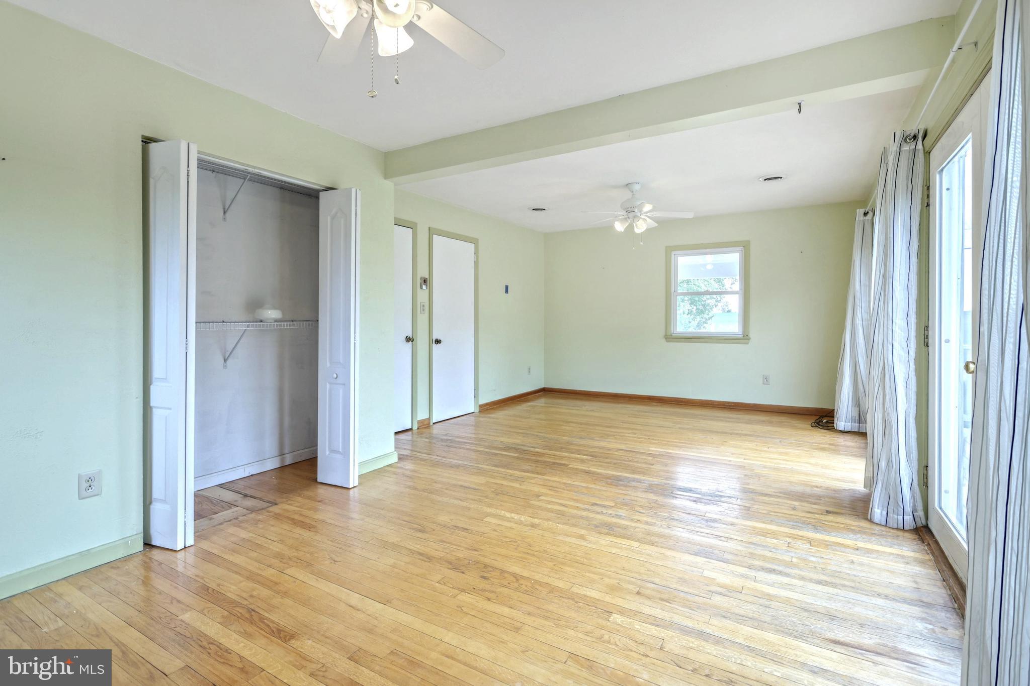147 Mud College Road Littlestown, PA 17340 - Photo 17 of 43 a view of empty room with window and wooden floor