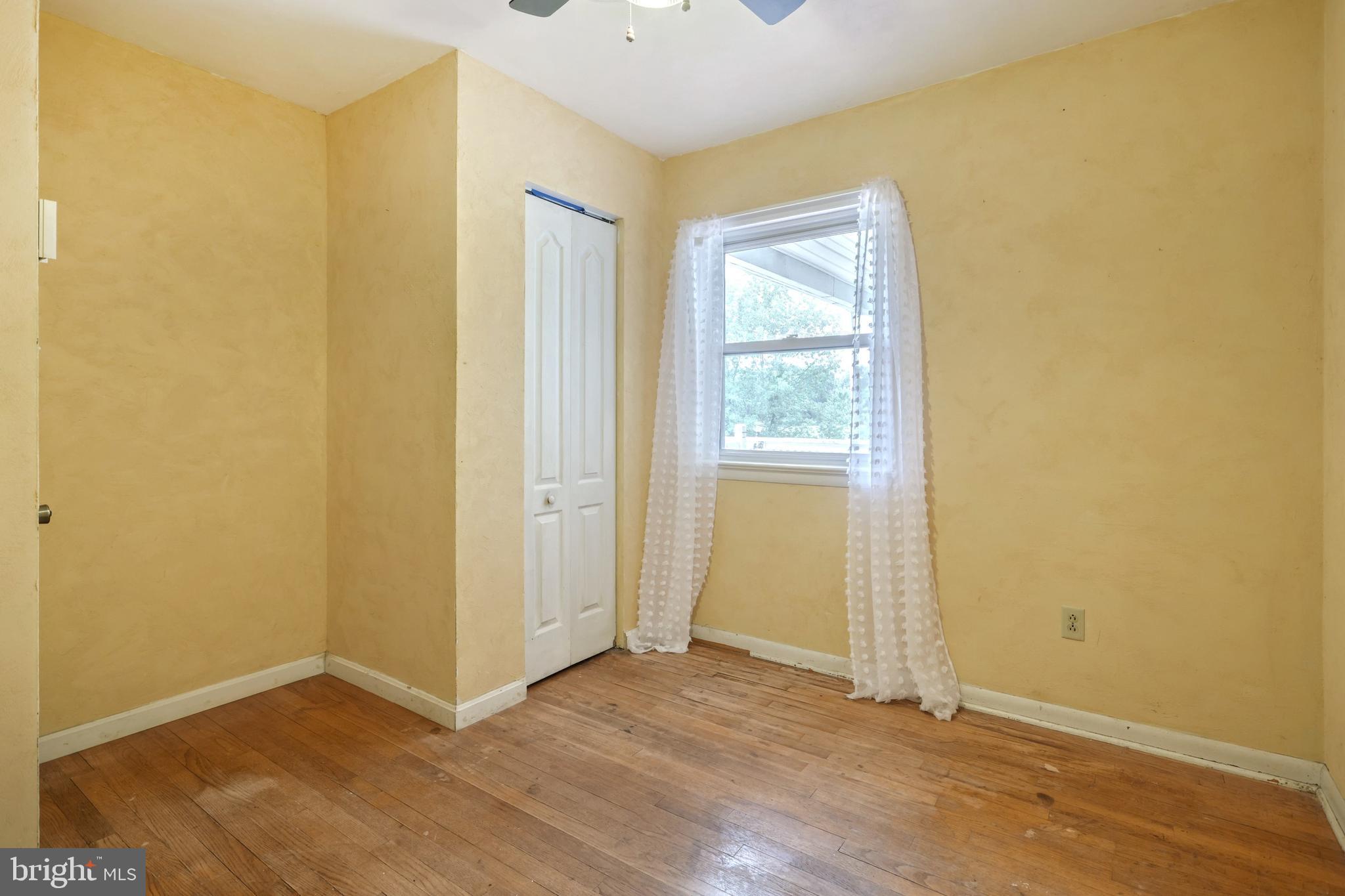 147 Mud College Road Littlestown, PA 17340 - Photo 18 of 43 an empty room with wooden floor and windows
