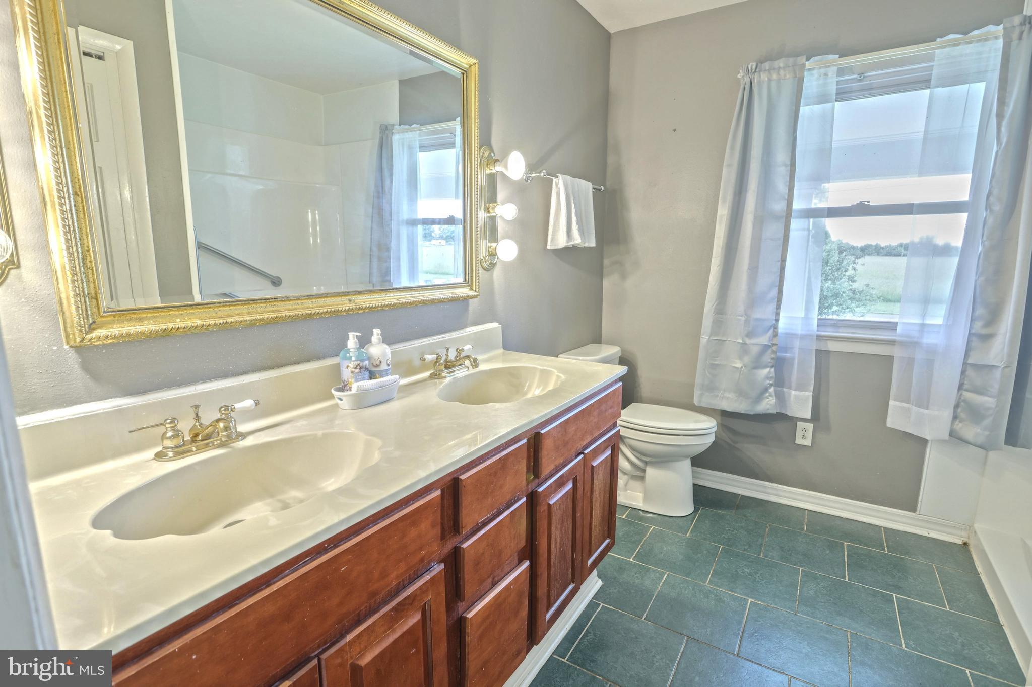147 Mud College Road Littlestown, PA 17340 - Photo 19 of 43 a bathroom with a sink a toilet and a mirror