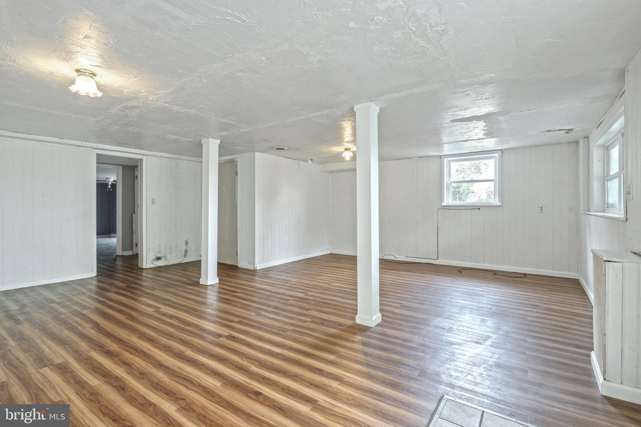 147 Mud College Road Littlestown, PA 17340 - Photo 21 of 43 a view of an empty room with wooden floor and a window