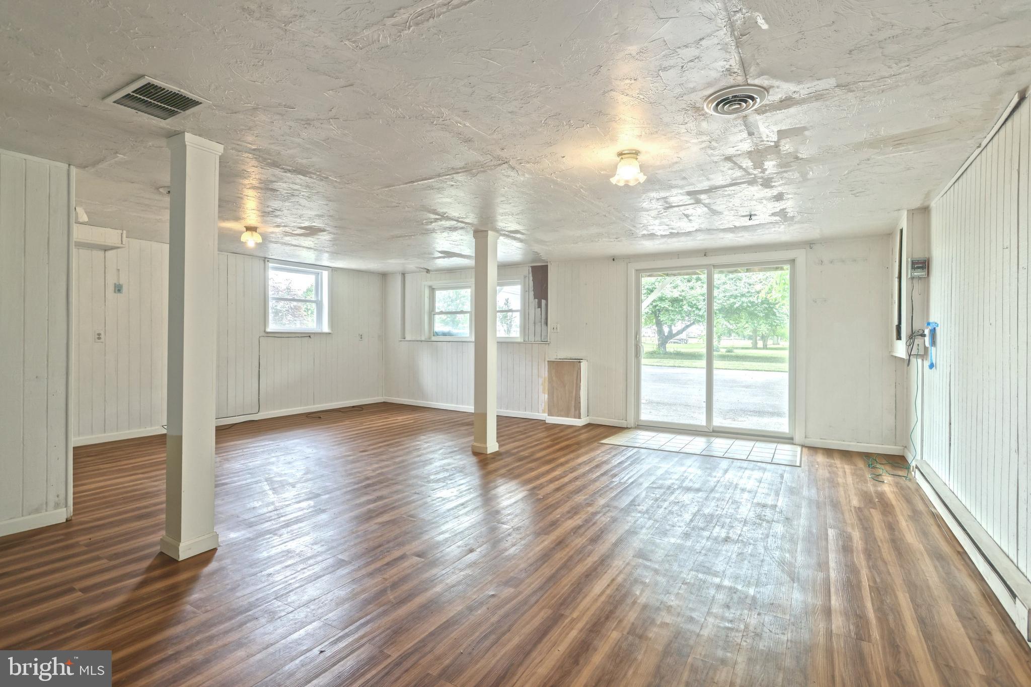 147 Mud College Road Littlestown, PA 17340 - Photo 22 of 43 a view of an empty room with wooden floor and a window