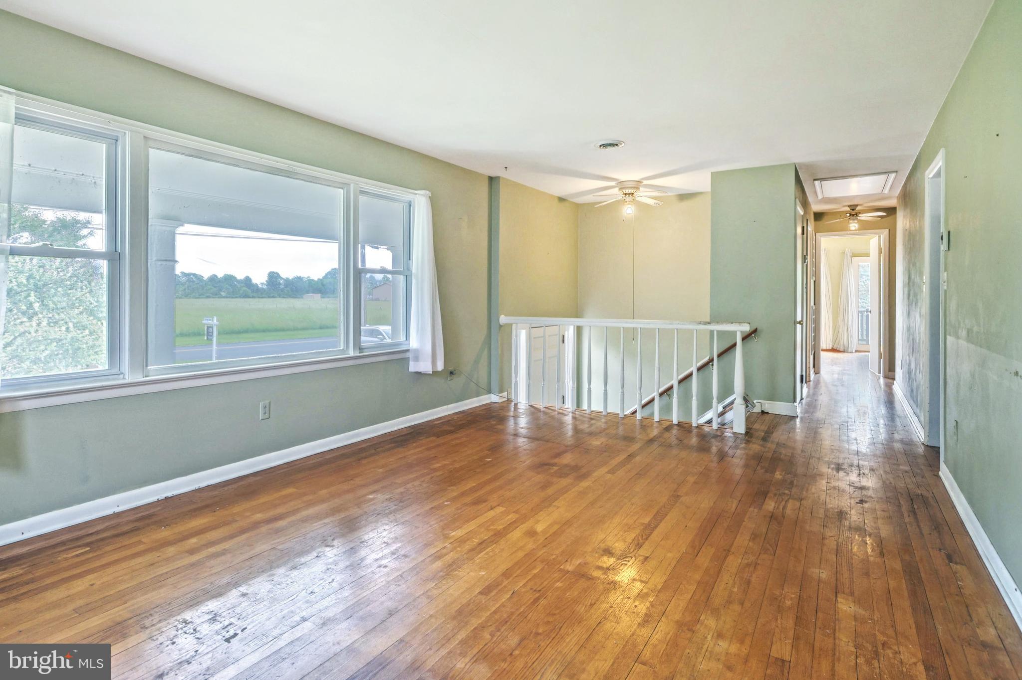 147 Mud College Road Littlestown, PA 17340 - Photo 5 of 43 a view of empty room with wooden floor and fan