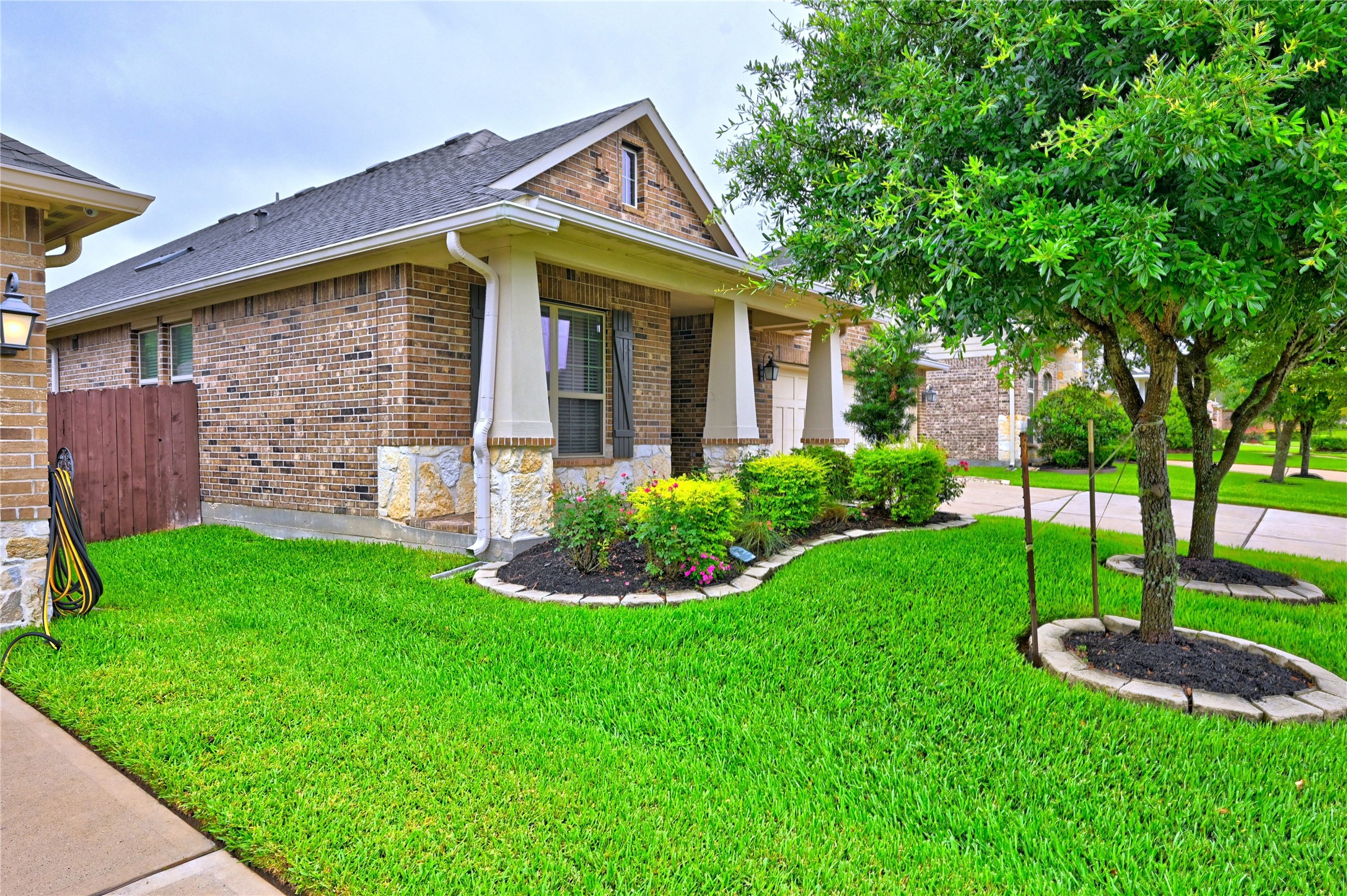 23118 Southern Brk Trail Spring, TX 77389 - Photo 3 of 50 A great view of the covered front porch and the lovely professionally landscaped yard. The two oak trees in framing the house are really lush and green.