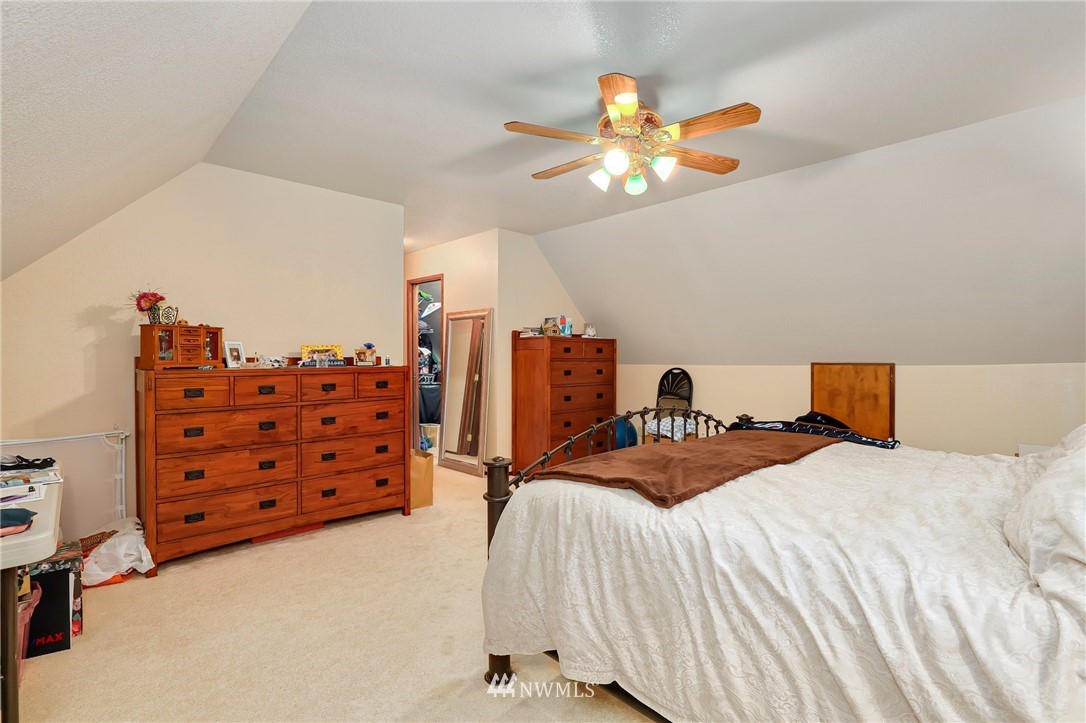 4313 212th Street Southeast Bothell, WA 98021 - Photo 22 of 40 a bed room with a bed and a chandelier