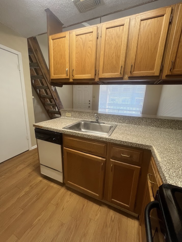 2210 Pearl Street, Unit 302 Austin, TX 78705 - Photo 11 of 18 a room with wooden floor and chair