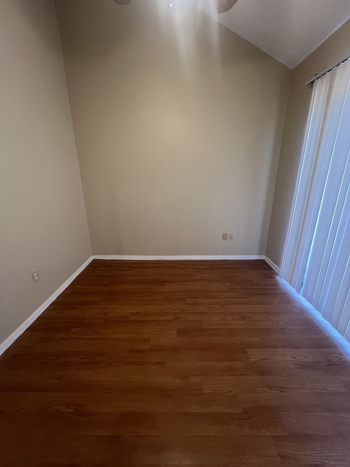 2210 Pearl Street, Unit 302 Austin, TX 78705 - Photo 15 of 18 an empty room with wooden floor and windows