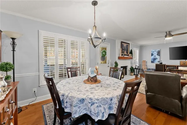 a living room with fireplace furniture and a wooden floor