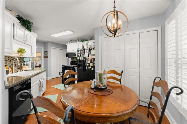 a kitchen with cabinets and wooden floor