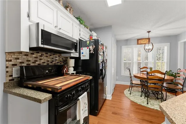 a bedroom with a bed chairs and window