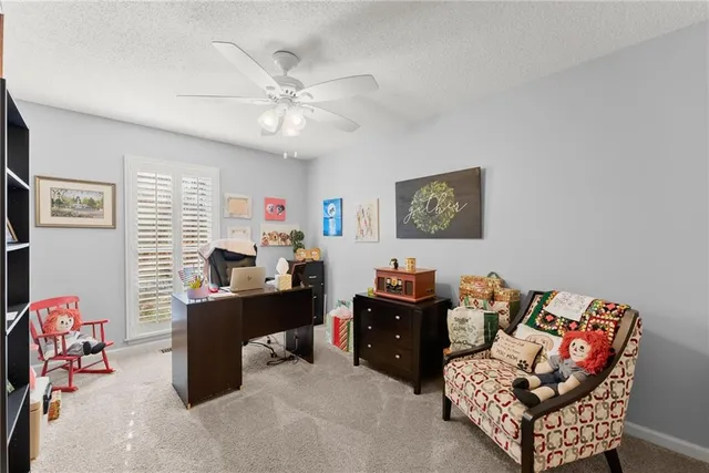 a bedroom with a white bed and a chandelier