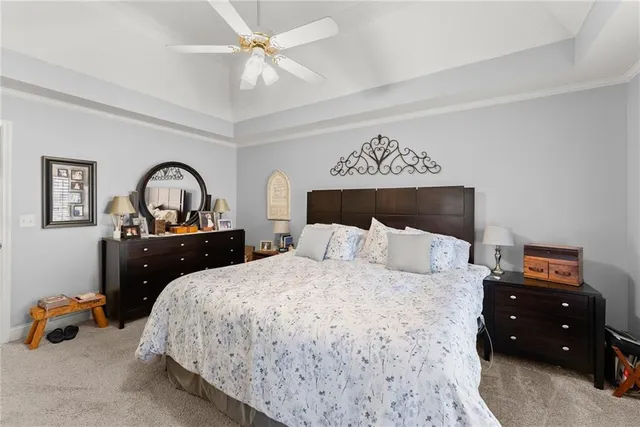 a en suite bathroom with a granite countertop sink and a mirror