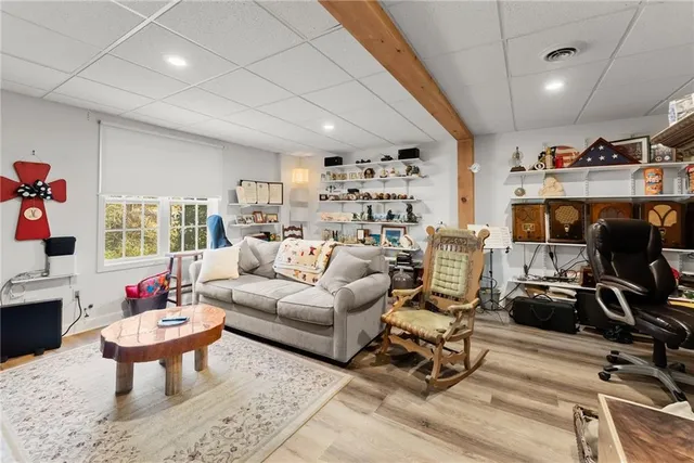 a living room with furniture and floor to ceiling windows