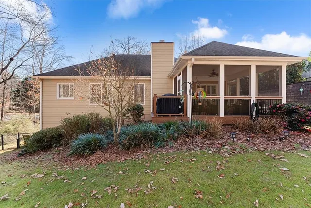 a backyard of a house with fire pit and chairs