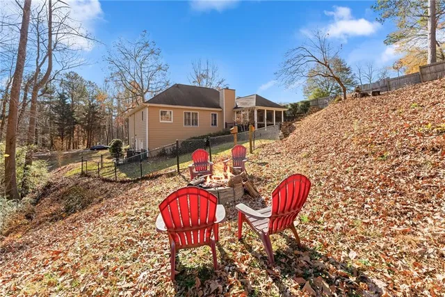 an aerial view of residential houses with outdoor space and trees