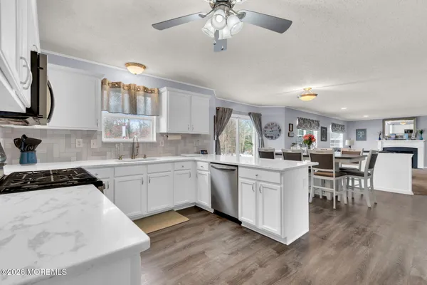 a kitchen with a sink stainless steel appliances and cabinets