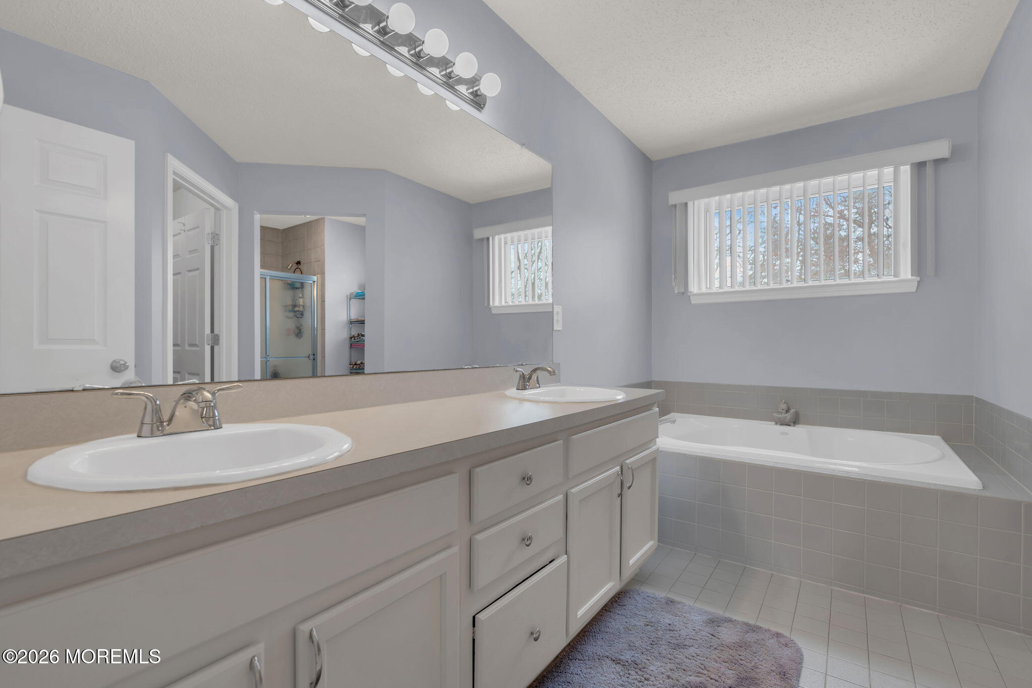 93 West Shenendoah Road Howell, NJ 07731 - Photo 24 of 30 a spacious bathroom with a double vanity sink large mirror and bathtub