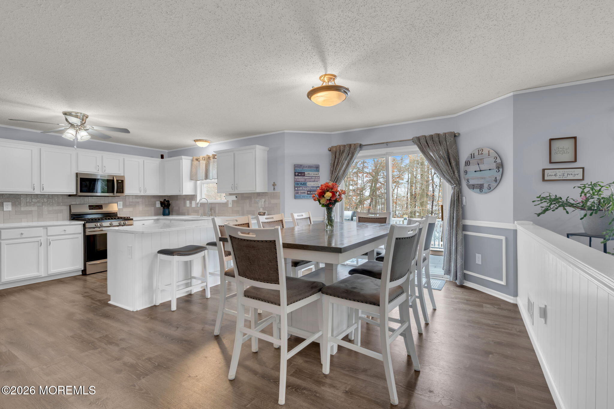 93 West Shenendoah Road Howell, NJ 07731 - Photo 8 of 30 a view of a dining room with furniture a kitchen and chandelier