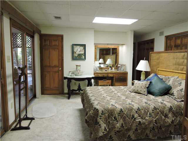 322 Raintree Road Timberlake, NC 27583 - Photo 11 of 25 a bedroom with a large bed and a window