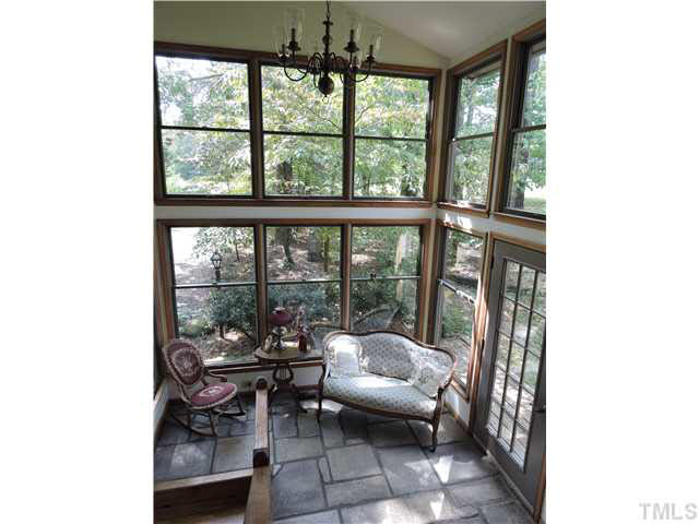 322 Raintree Road Timberlake, NC 27583 - Photo 3 of 25 a living room with furniture and a floor to ceiling window