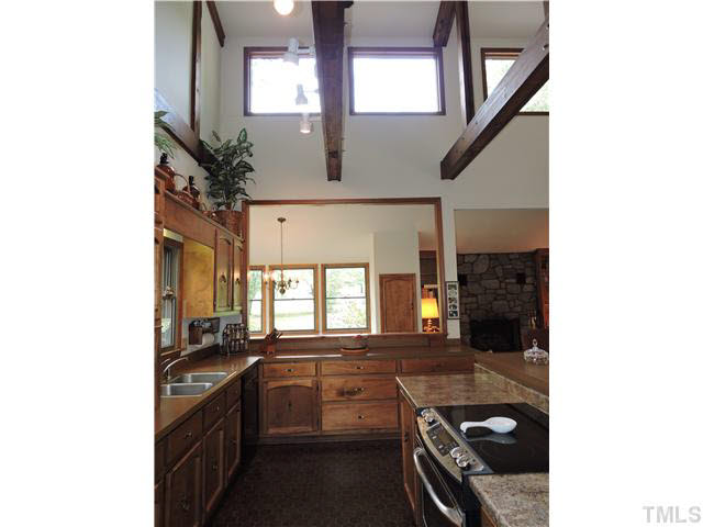 322 Raintree Road Timberlake, NC 27583 - Photo 6 of 25 a kitchen with a sink stove and cabinets