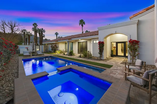 a swimming pool with outdoor seating yard and yard