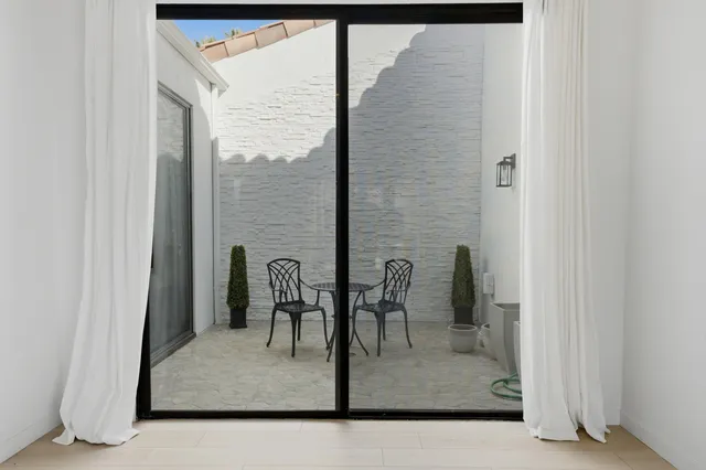a view of a room with a table and chairs