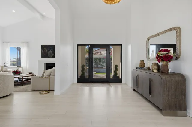 a living room with furniture and large windows