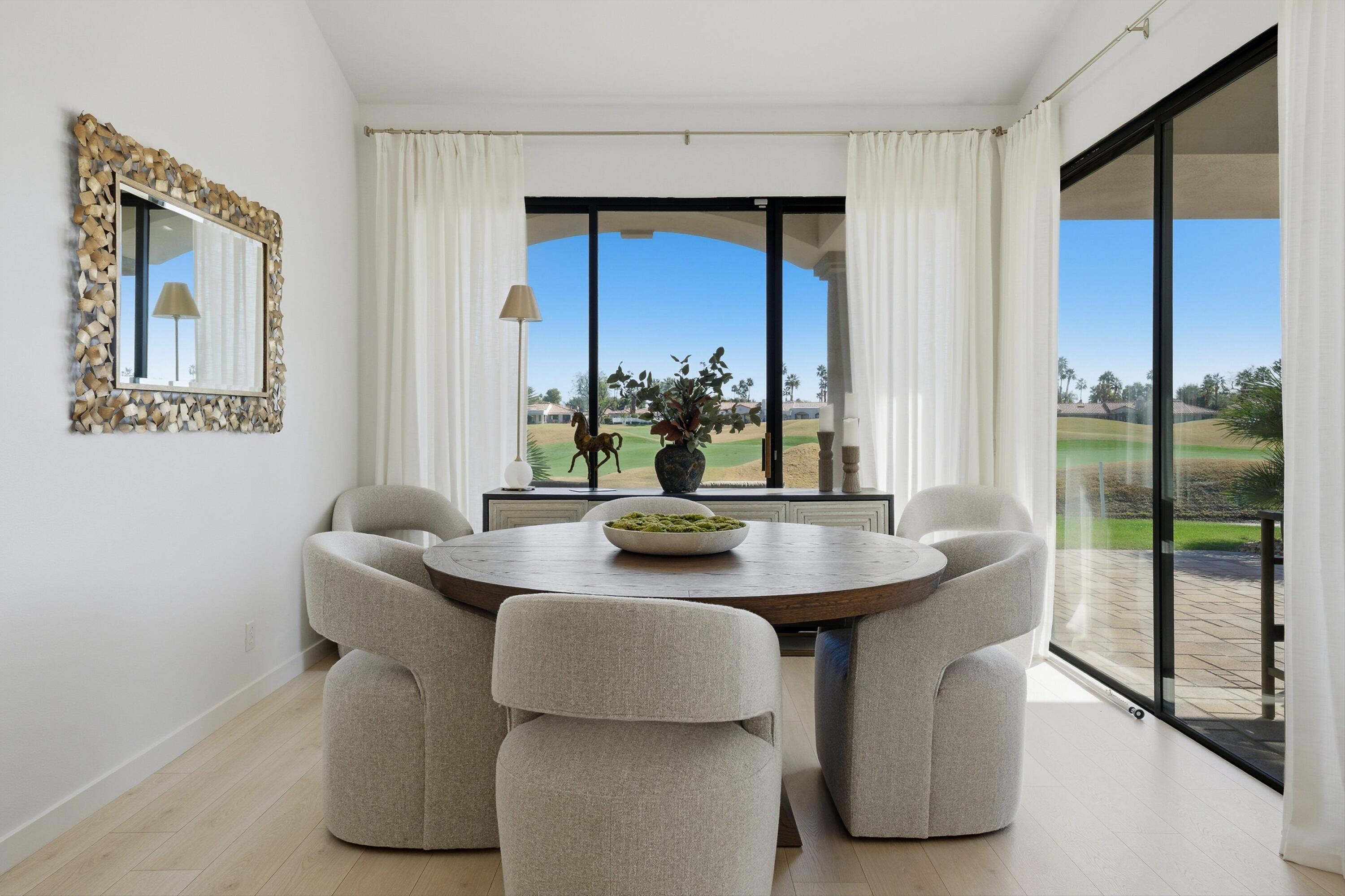 56300 Pebble Beach La Quinta, CA 92253 - Photo 23 of 45 a dining room with furniture and a large window