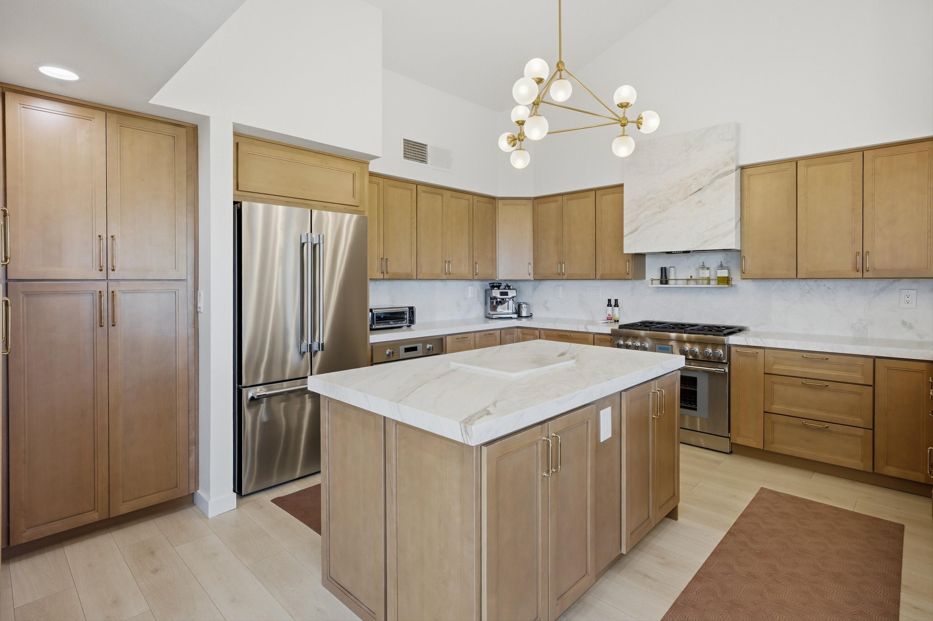 56300 Pebble Beach La Quinta, CA 92253 - Photo 27 of 45 a kitchen with a refrigerator a sink cabinets and a window