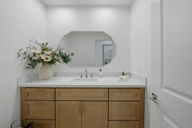 a bathroom with a sink a vanity and a mirror