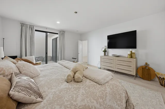 a bedroom with a bed and a television