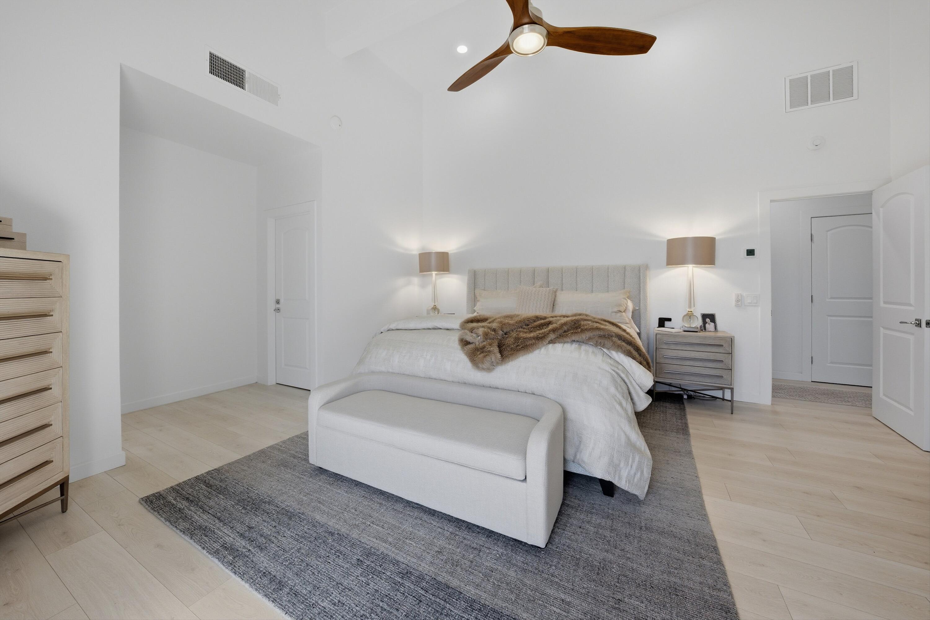 56300 Pebble Beach La Quinta, CA 92253 - Photo 40 of 45 a spacious bedroom with a bed and a chandelier