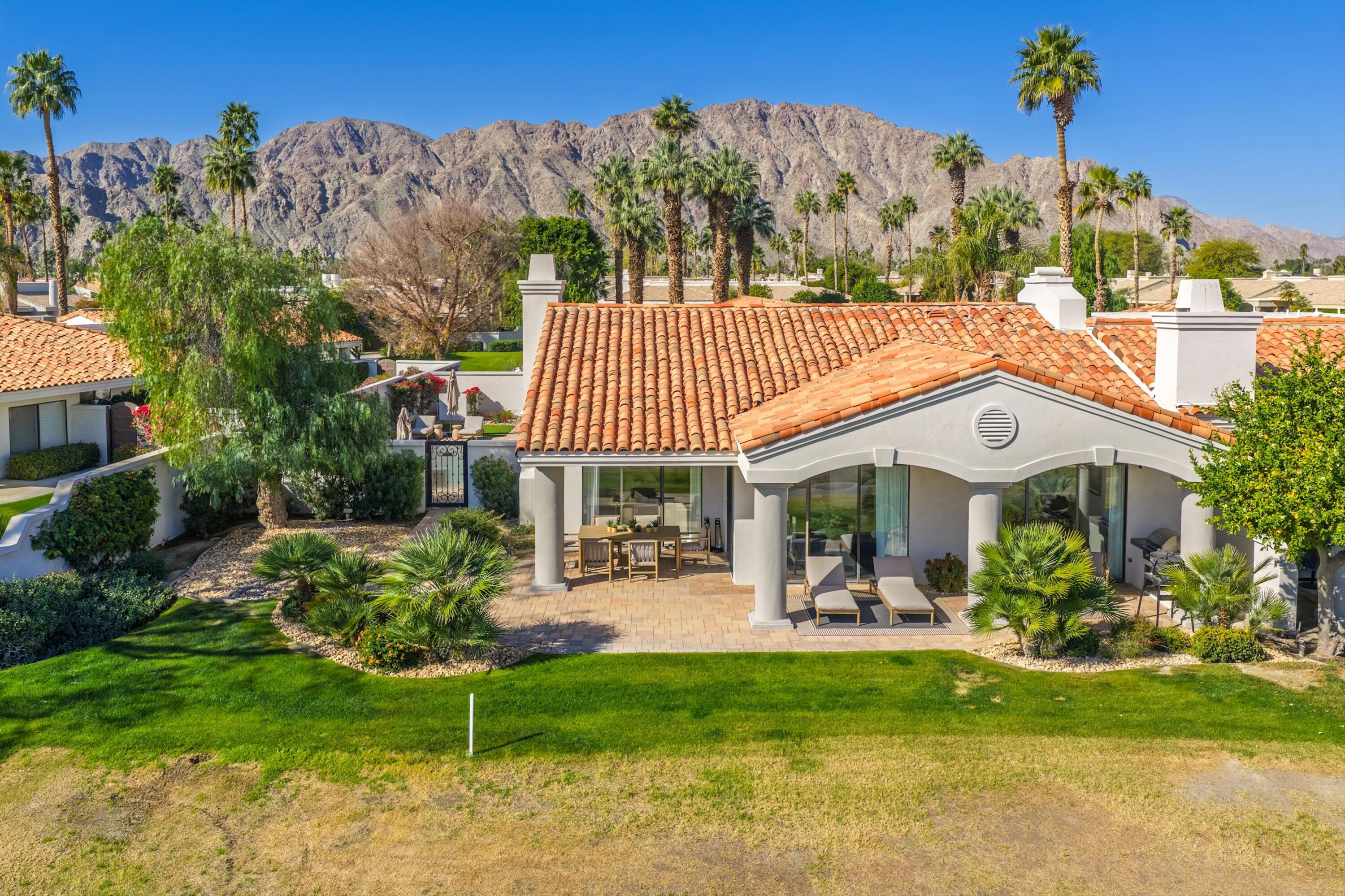 56300 Pebble Beach La Quinta, CA 92253 - Photo 9 of 45 a view of a patio with furniture and a garden