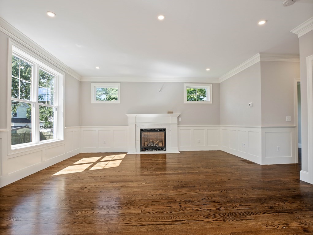 25 Larkin Road Newton, MA 02465 - Photo 6 of 27 a view of an empty room with window and fire place