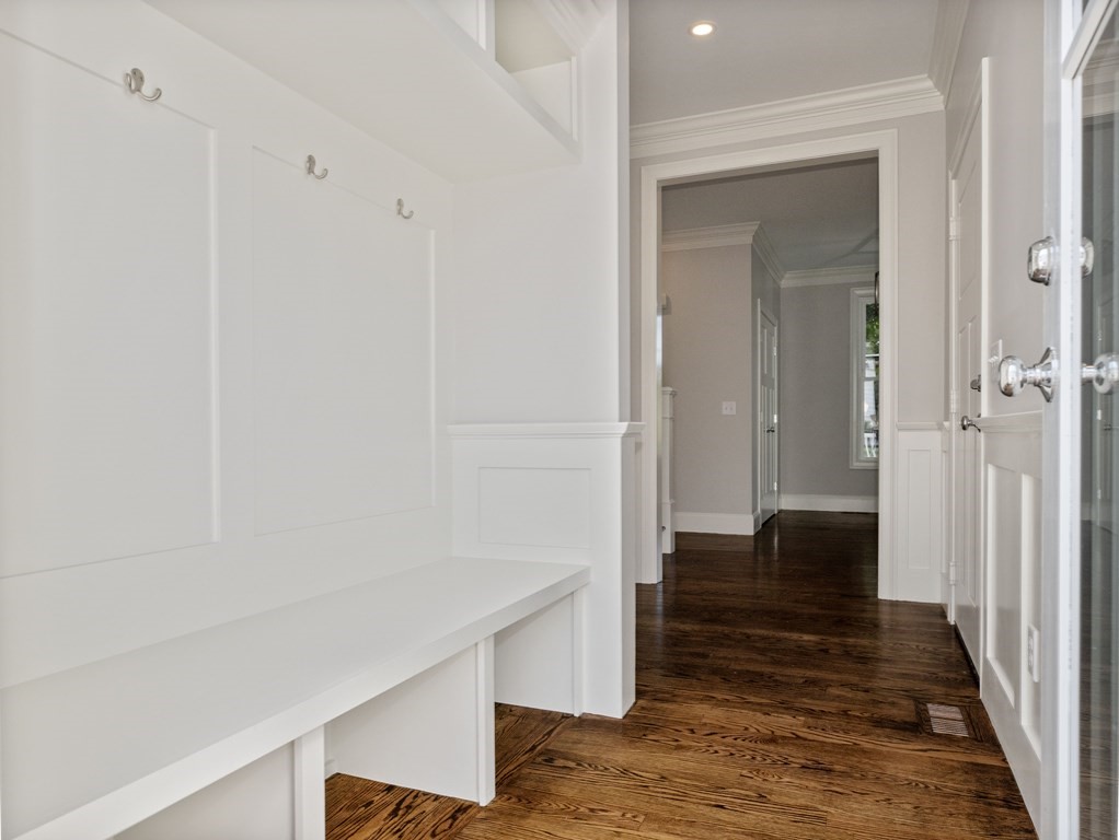 25 Larkin Road Newton, MA 02465 - Photo 8 of 27 a view of a hallway with wooden floor and staircase