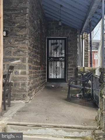 a view of a brick house with many windows next to a road