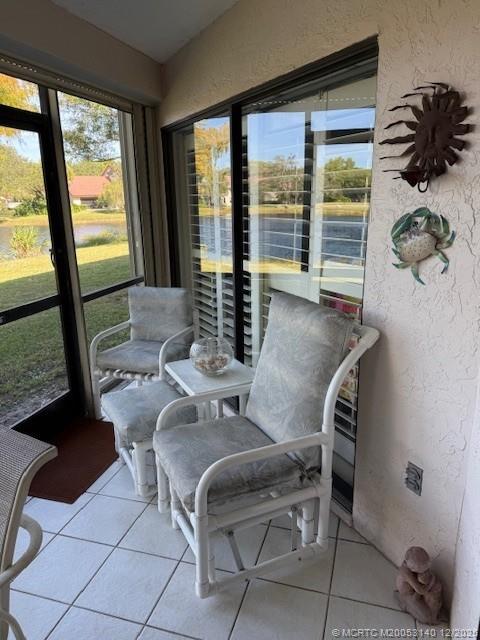 3480 Southeast Martinique Trace, Unit 102 Stuart, FL 34997 - Photo 20 of 24 a dining room with furniture and large windows