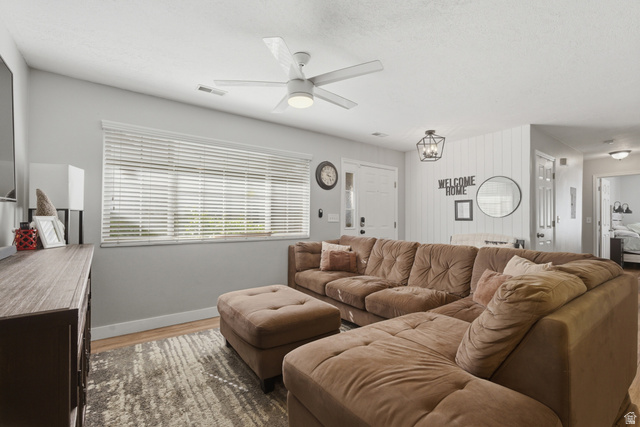 282 West 960 South, Unit C Provo, UT 84601 - Photo 3 of 33 Living room featuring wood finished floors, ceiling fan, and hanging lights