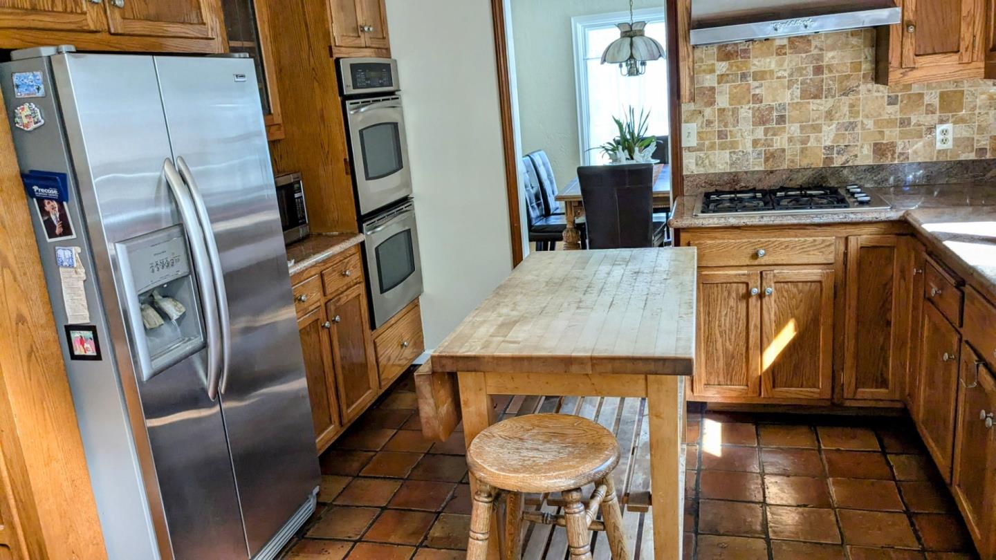 943 Riverside Drive San Jose, CA 95125 - Photo 5 of 13 a kitchen with stainless steel appliances granite countertop a refrigerator a stove and white cabinets