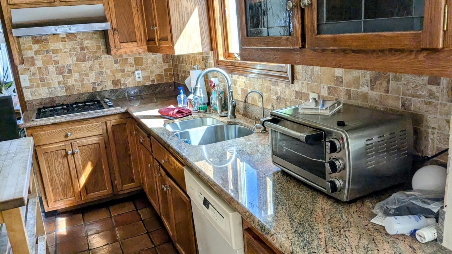 943 Riverside Drive San Jose, CA 95125 - Photo 8 of 13 a kitchen with stainless steel appliances granite countertop a sink and a stove