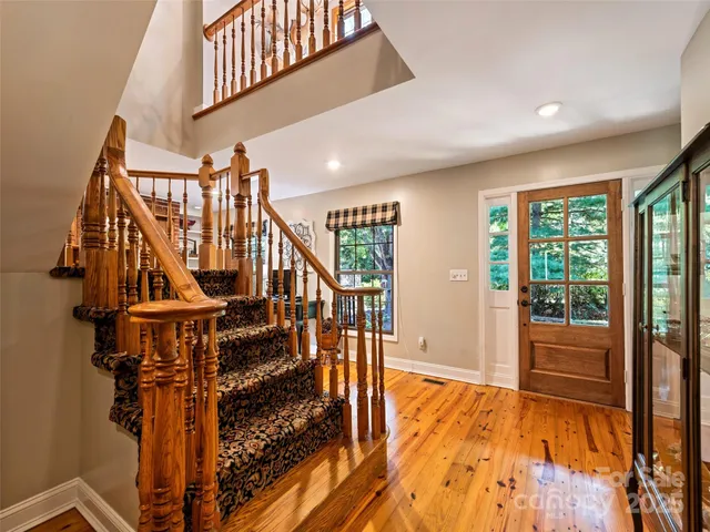 a view of entryway with wooden floor and windows