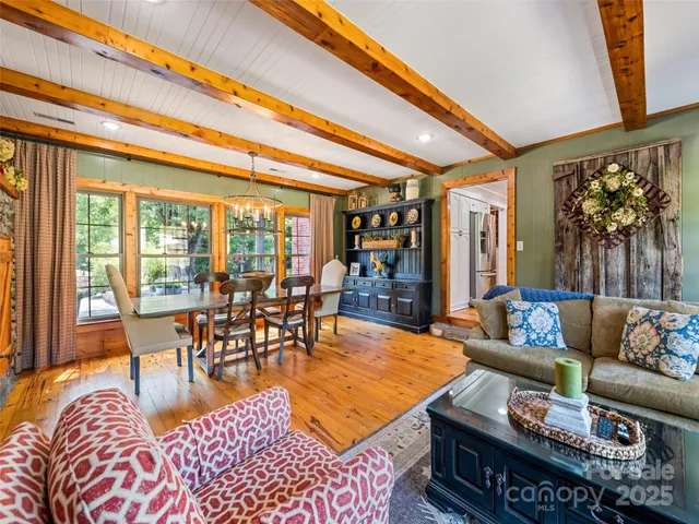 a living room with furniture a rug and a large window
