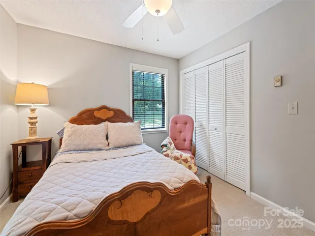 a bedroom with a bed and a lamp