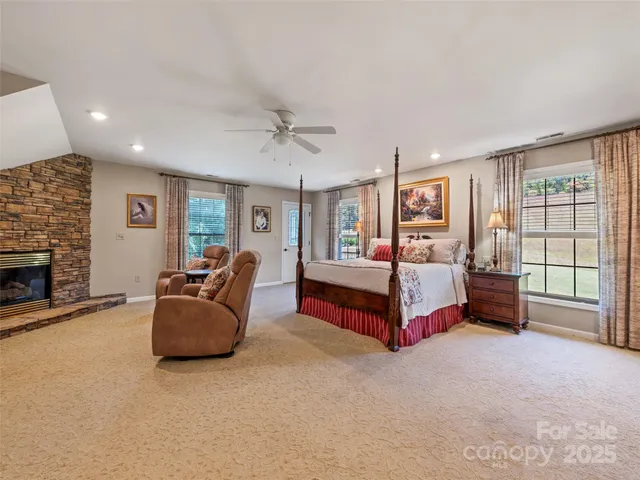a bedroom with furniture and a fireplace