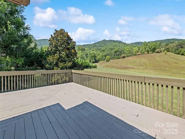 a balcony with wooden floor and fence