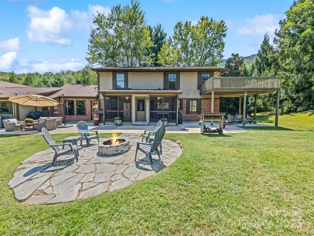 a view of a house with pool and chairs